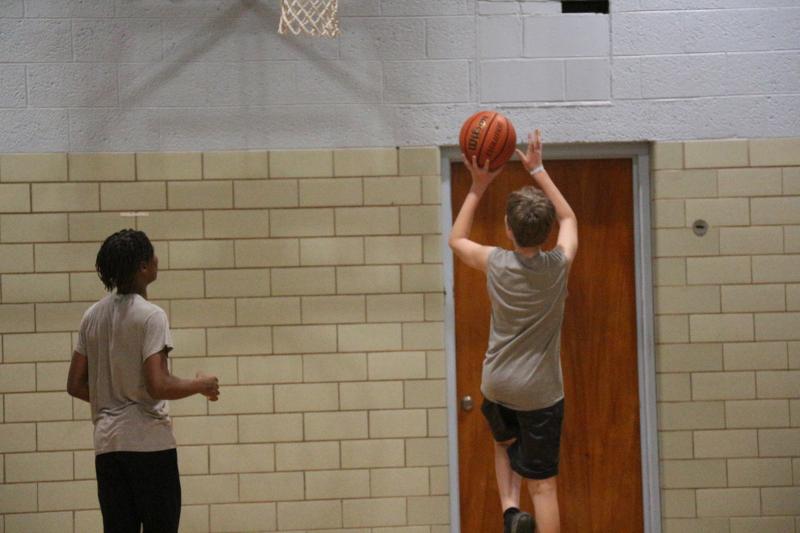 Devin Park has a sense of where a player's skill level is and trains them accordingly. He said Geordan Downing is a budding star he includes with the older kids during pickup games, but also relies on as a leader when the younger age group plays together. Silas Condon is just starting to pick up basketball, but Devin sees a lot of promise in him. Shown are Downing, left, and Condon. AARON MUSHRUSH PHOTO