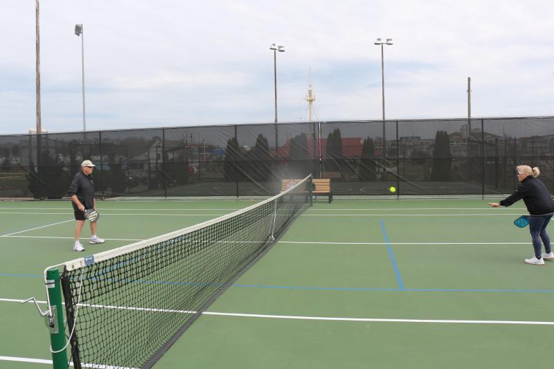 Some former Canalfront Park court regulars say they can no longer use the facilities due to the surface condition issues. Tim and Diane Bane are shown volleying back and forth.