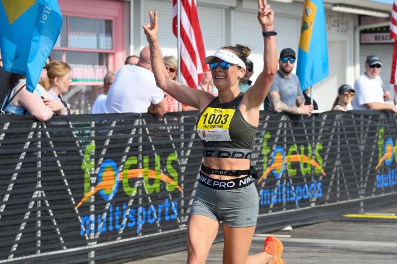 Erin Fitzgerald is the first woman to cross the finish line in the half-marathon with a time of 1:24:10.