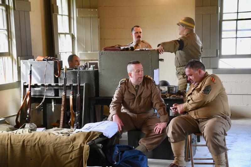 Reenactors take up their posts in one of Fort Miles’ barracks open to the public with authentic World War II gear and weapons on display.