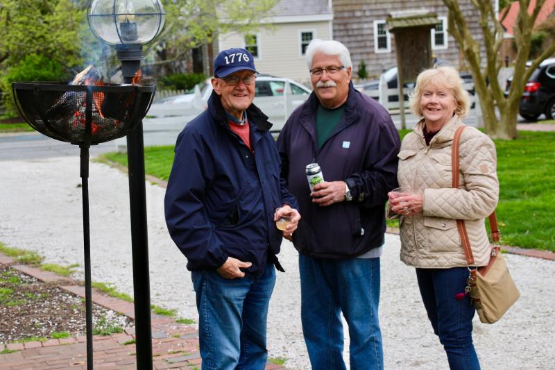 Jack Bowser, left, had the important job of keeping the fire going. John Kujawski and his wife Anne Marie Kujawski appreciated the warm hospitality.