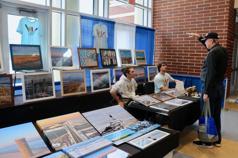 Gavin Birl, left, and Chris Rubino, founders of GC Studios, talk to the Rev. Vern Caswell of Southern Delaware Christians about pickles and photography.