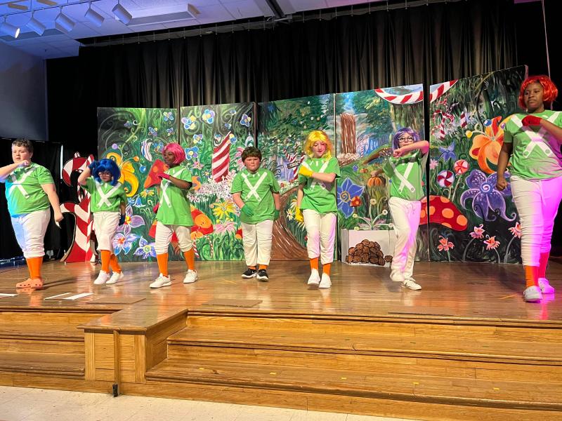 Portraying the dancing Oompa Loompas are (l-r) Landon Bosley, Taegan Pezold, Le'Andria Sunkett, Hunter Cosme, Anastasia Lynn, Lydia Brown and Na'Riaha Jones.