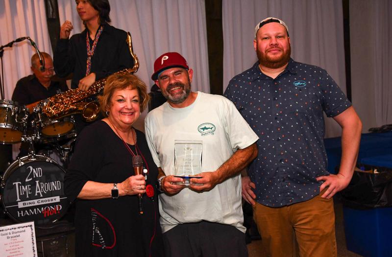 Meals on Wheels Event Chair Lana O'Hollaren presents third-place honors to Dogfish Head Brewings & Eats. Shown are (l-r) O'Hollaren, and chefs Bill Rogers and Jordan Drew.