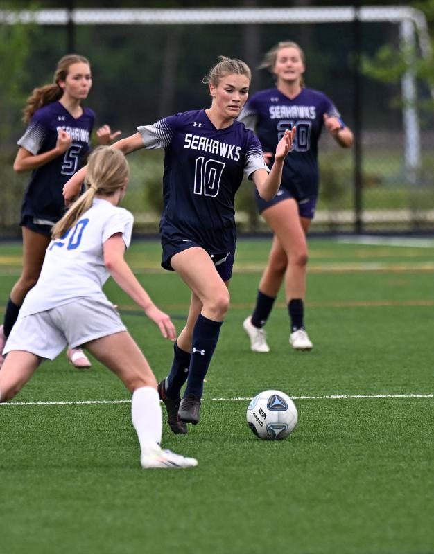 Sussex Academy junior Catherine Brown speeds the ball past CR’s Emma Oehmke.