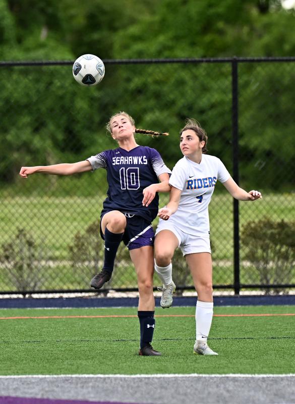 Catherine Brown heads the ball away from Alexandra Soghomonian.