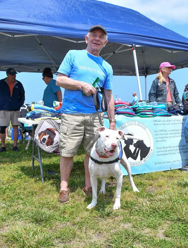 Grass Roots Rescue volunteer Cliff Rose holds Nibbles who awaits his turn at being adopted to a furever home.