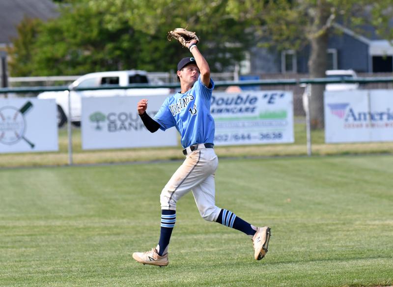 Cape shortstop Timothy Hitchcock looks back as he snags a fly ball in the shallow outfield.