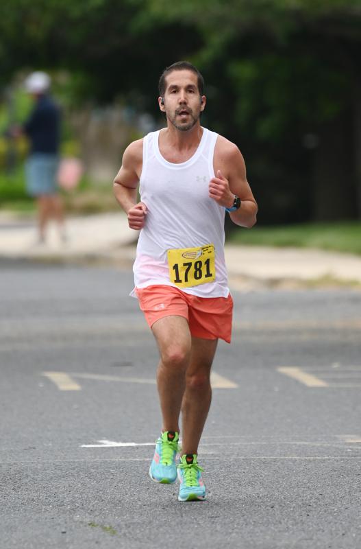 Matt Sparacino, 45, of Harrington heads through Nassau Commons toward the finish line to win the race.