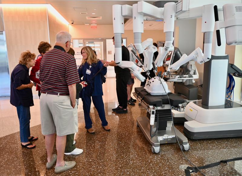 A large crowd gets a chance to operate a surgical robot during an event at the Beebe Healthcare Specialty Surgical Hospital.