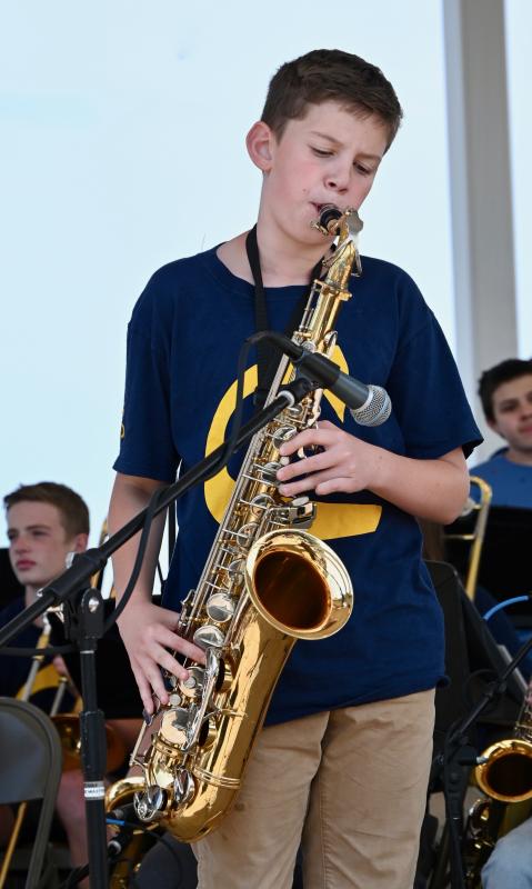 Mark Lally takes center stage on the Bandstand during a saxophone solo in the band’s rendition of “My Little Suede Shoes.”