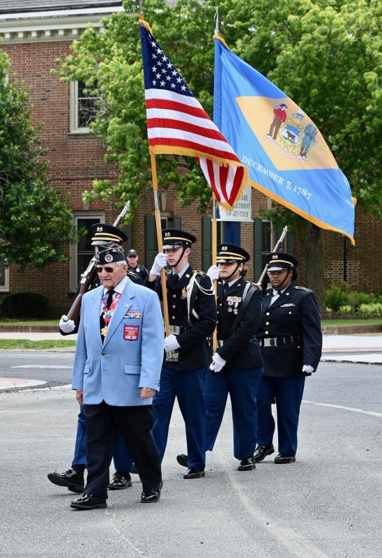 Korean War veteran Walter Koopman leads the Sussex Central High School Army JROTC color guard to the ceremony.