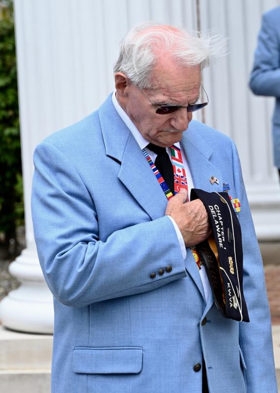 Veteran Walt Koopman, an active member of Chapter 1 of the Delaware Korean War Veterans Association, bows his head in prayer during the invocation.