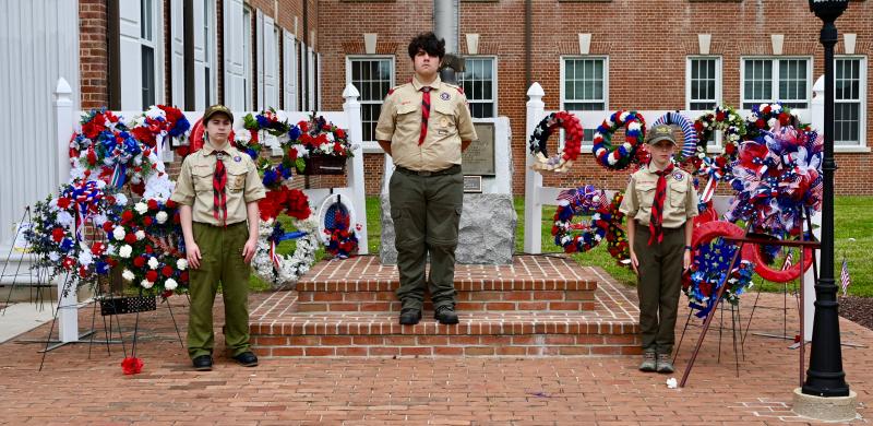 Boy Scout Troop 95 members stand at attention as they provide watch over the numerous wreaths provided by veterans and community organizations.