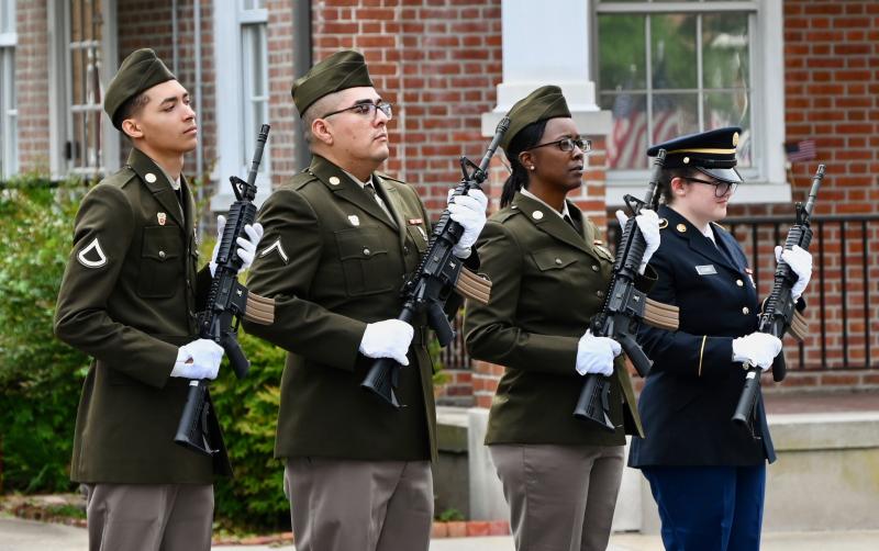The rifle team from the National Guard 198th Signal Battalion in Georgetown prepares to fire a salute.