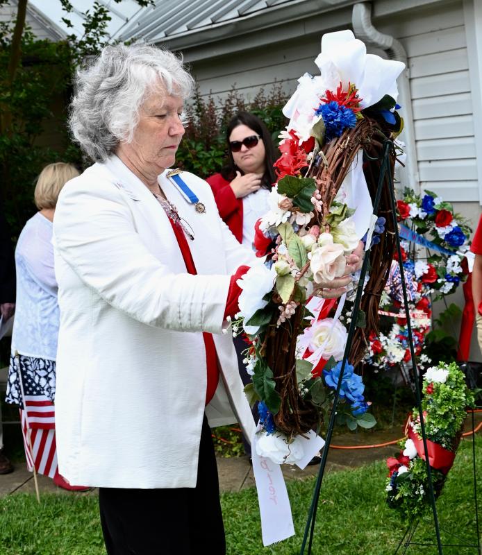 Patricia Hass, Col. David Hall Chapter regent, lays a wreath on behalf of the local Daughters of the American Revolution.