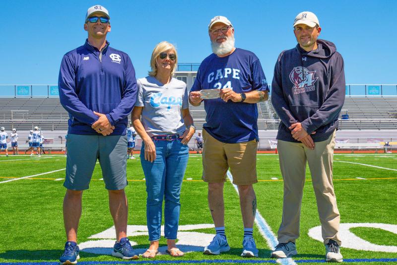 The Cape team boosters and the Appo team present a check to Scott Brozey’s friend Dan Cook for the Scott Brozey Lead by Example Memorial Scholarship. Shown are (l-r) Cape coach Geoff Shupard, Cape boosters representative Kim Burton, Cook and Appo coach Mike McGuigan. McGuigan was Brozey’s teammate on the Delaware Tech and Wesley College teams. JEFF TRENCH PHOTO