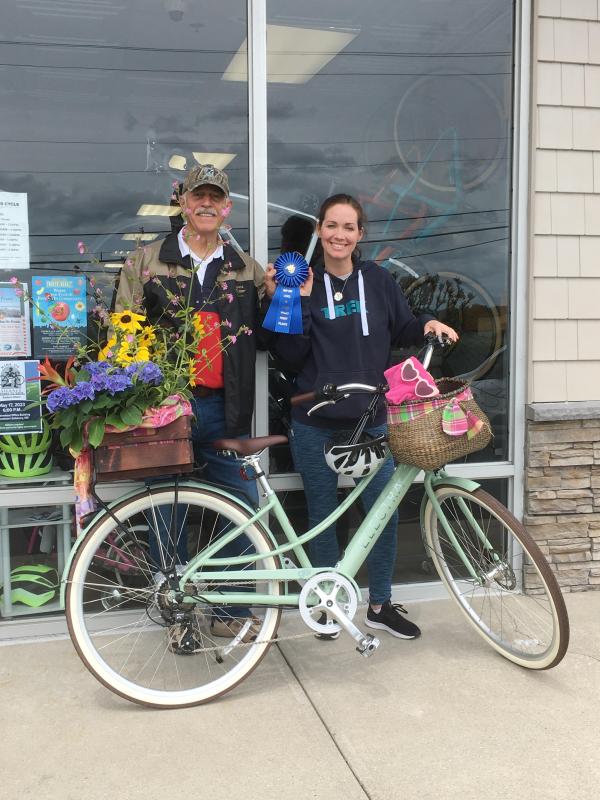 Megan Kellman, right, said Dennis Chandler collaborated with Lewes Cycle Sports to construct the winning basket in the business category. PHOTO COURTESY OF MEGAN KELLMAN