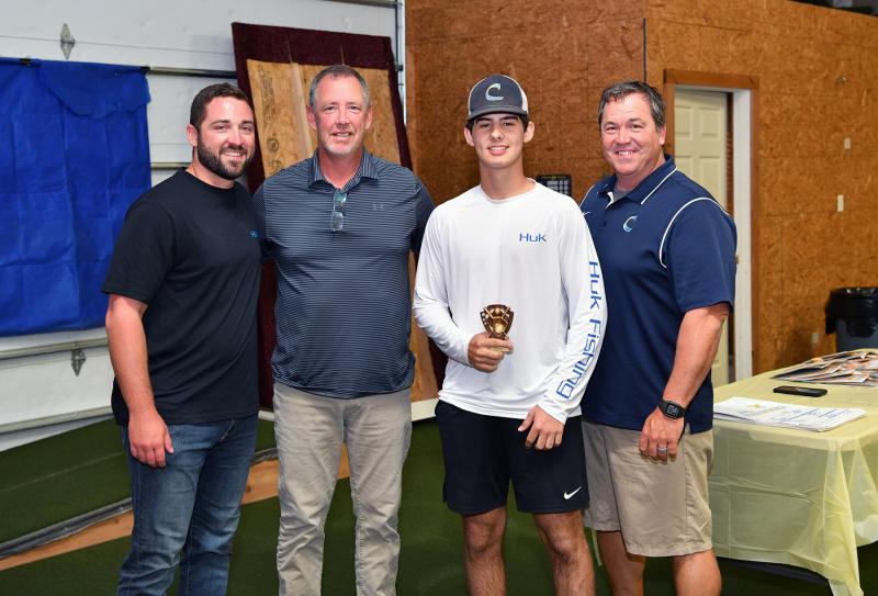 The JV Defensive MVP was presented to Noah Wells. Shown are (l-r) assistant coach Seth Brosius, assistant coach Drew Johnson, Wells and head coach Ben Evick.