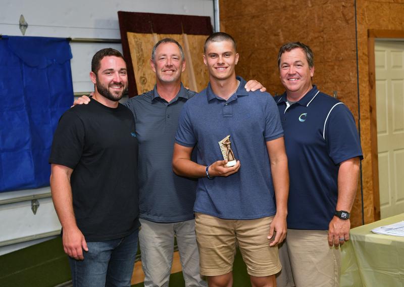 Brenn Scott received the Defensive MVP. Shown are assistant coach Seth Brosius, assistant coach Drew Johnson, Scott and head coach Ben Evick.
