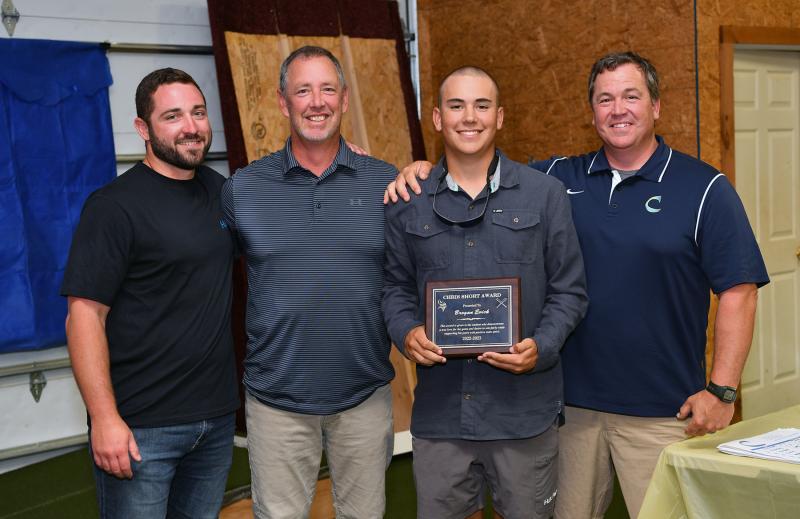 Brogan Evick received the Chris Short Award. Shown are (l-r) assistant coach Seth Brosius, assistant coach Drew Johnson, Evick and head coach Ben Evick.
