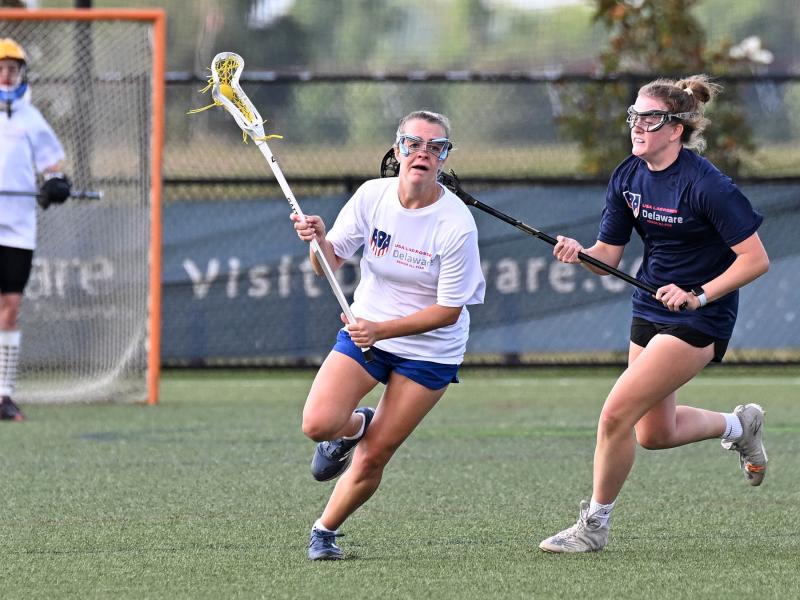 White squad defender Mackinzie Brown clears the ball past Blue team attack Rebecca Olsen of Archmere.
