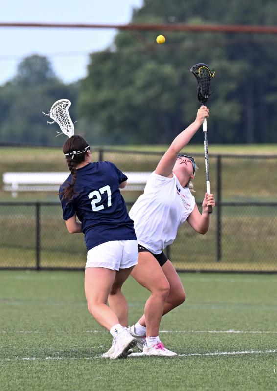 White team midfielder Sanne Elling of Sussex Academy, right, wins the draw from Morgan Wallace of Middletown.