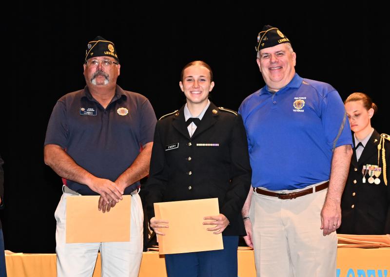 Cora Emory receives the American Legion Post 17 Scholastic Excellence Award from Steve Barrow, left, and Steve Missimer.