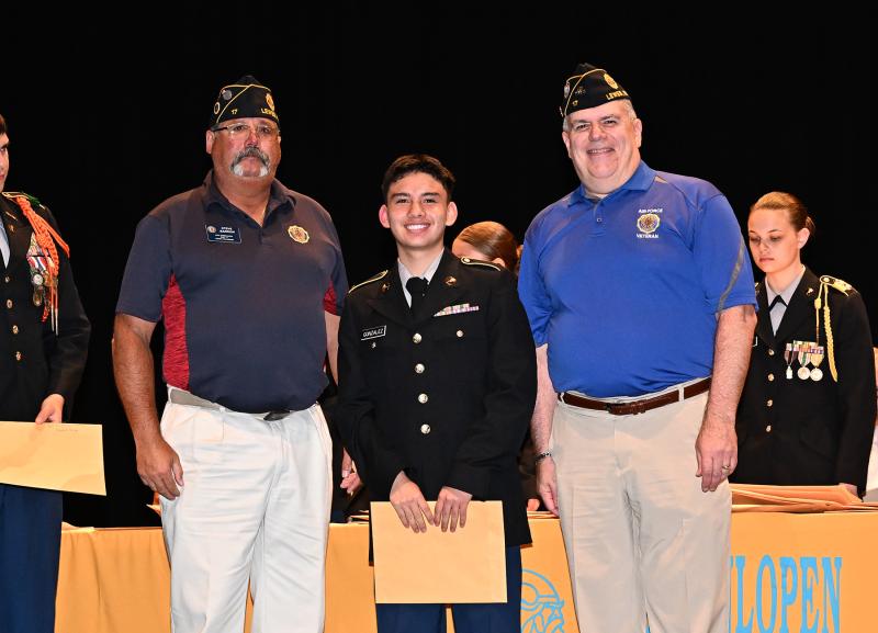 Dilian Gonzalez receives the American Legion Post 17 Award for Americanism from Steve Barrow, left, and Steve Missimer.