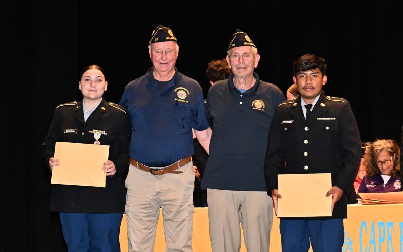 American Legion Post 28 officers Jim Beattie and Joe Brown present the Medal of Merit to Gabriella Brunskill, left, and Jonathen Miranda.