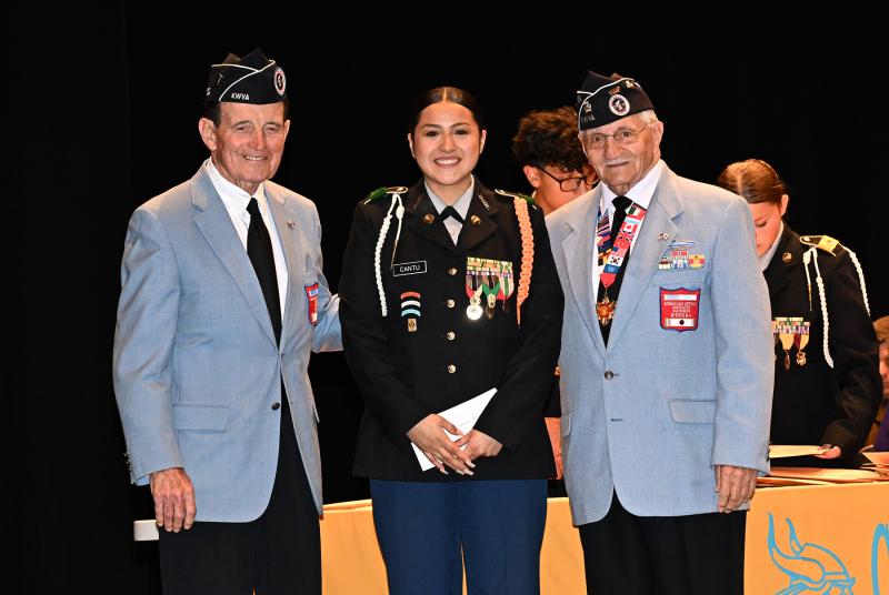 Ninfa Cantu receives the Korean War Veterans Association Award from Jack McGinly, left, and Walt Koopman.