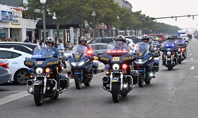 Delaware State Police Sgt. Gary Fournier, left, of the Delaware State Police leads the Torch Run for the last time. He was named the 2022 Winnie Spence Torch Runner of the Year. He has volunteered with the Special Olympics Delaware for more than 25 years.