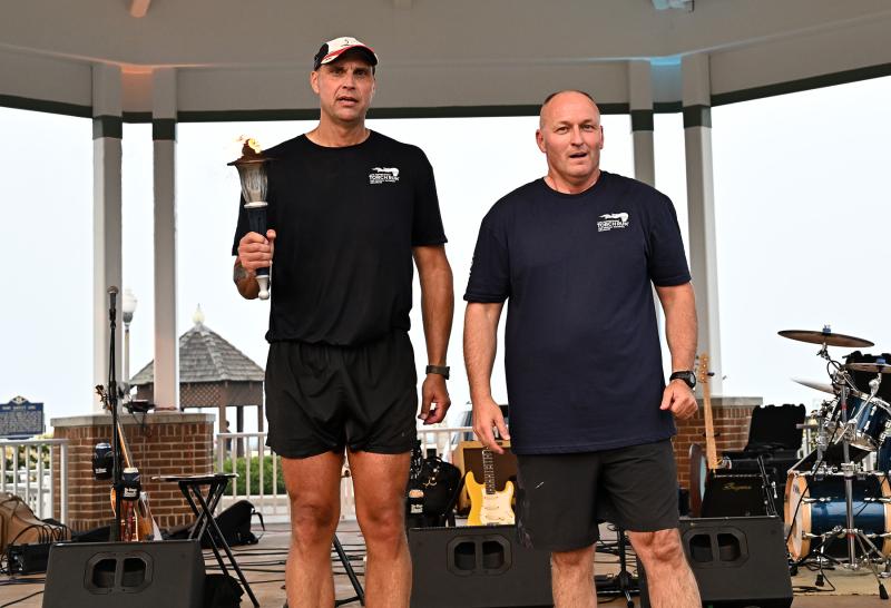 The Flame of Hope was passed from Department of Correction Commissioner Monroe Hudson, right, to Cpl. Jeff Bixler of the Rehoboth Beach Police Department.