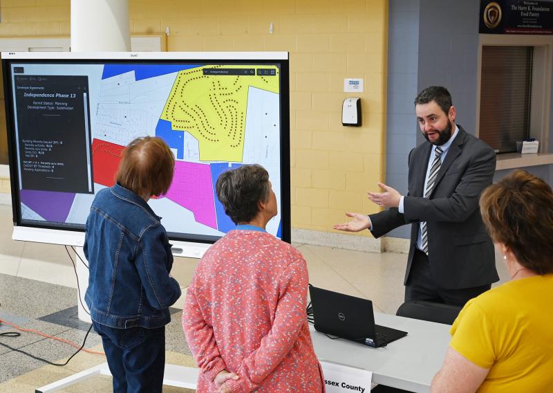Sussex County Planning & Zoning Director Jamie Whitehouse chats with some residents about Independence Phase 13 near Long Neck.
