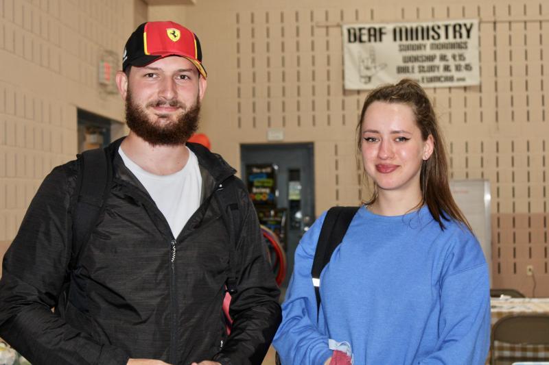 Romanian Manuel Mocanu and Ukrainian Victoria Khromey grabbed a few sanitary and household items following the meal June 20 at Epworth United Methodist Church.
