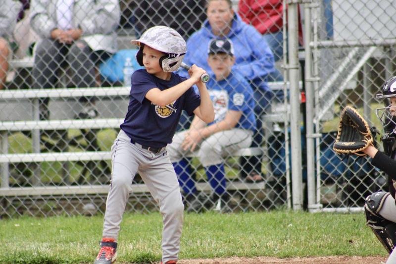 Milton 8-10 Pat Knight player Nash Dondarski looks at a pitch during the June 22 game. AARON MUSHRUSH PHOTO