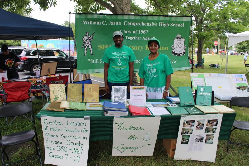 Janie Miller, president of the William C. Jason Comprehensive High School Alumni Association, poses with her son Reggie Miller, a former Special Olympics Delaware basketball standout, at the Jason High School informational booth. Miller had yearbooks from the past and other alumni memorabilia.