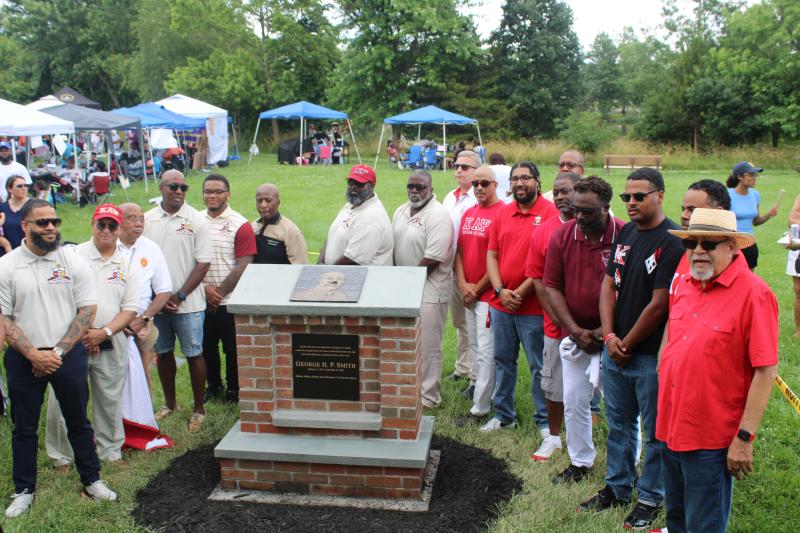 Dover alumni chapter of the Kappa Alpha Psi fraternity pays homage to one of its founding members, George H.P. Smith. Shown are (l-r) Ric Morgan, Phillip Nevius, Lawrence Hampton, Corey Crawford Sr., Terrell Cook, James Sherard, Cliffvon Howell, Tracy Chamblee, Mark Eisenhour, Blaine Daisey, Lance Edwards, Julius Mickens, Taj L. McNair, John Martin Jr., Jordan McCullough, Tiff McCullough and Cagney France.