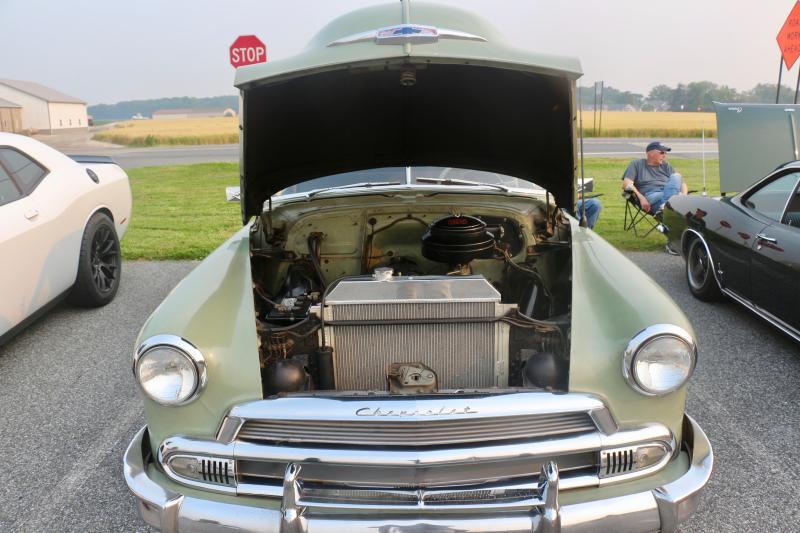 Tracy Koover’s 1951 Chevy Deluxe was the tone-setting car as folks strolled down the lineup of popped hoods and classic styles.