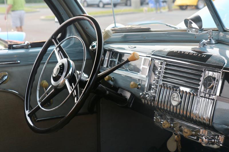 The chrome interior shines brightly in the 1948 Plymouth Club Coupe, but there doesn’t appear to be an auxiliary cord or rear camera in the dashboard. How could one listen to their podcast without a place to plug in or back up without cameras?
