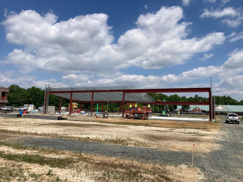 Workers put in trusses on what will eventually be a packing barn and event space.
