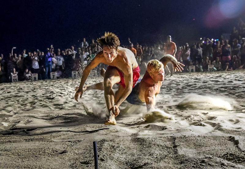 Rehoboth Beach Patrol’s Konner Knarr, left, takes a slim victory over Dewey’s CJ Fritchman in the beach flags competition.
