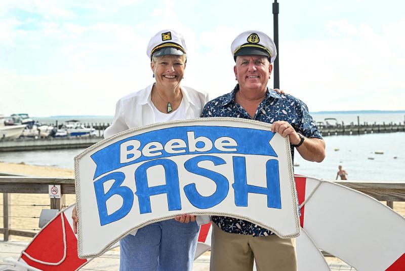 Beebe Medical Foundation Executive Director of Development Kay Young, left, and foundation President Tom Protack welcome guests to the annual Beebe Bash at the Lighthouse Cove in Dewey Beach.
