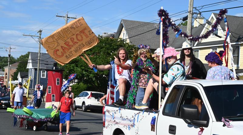 This collection of parade participants urges people to join their cause and eat more candy to save the carrots.