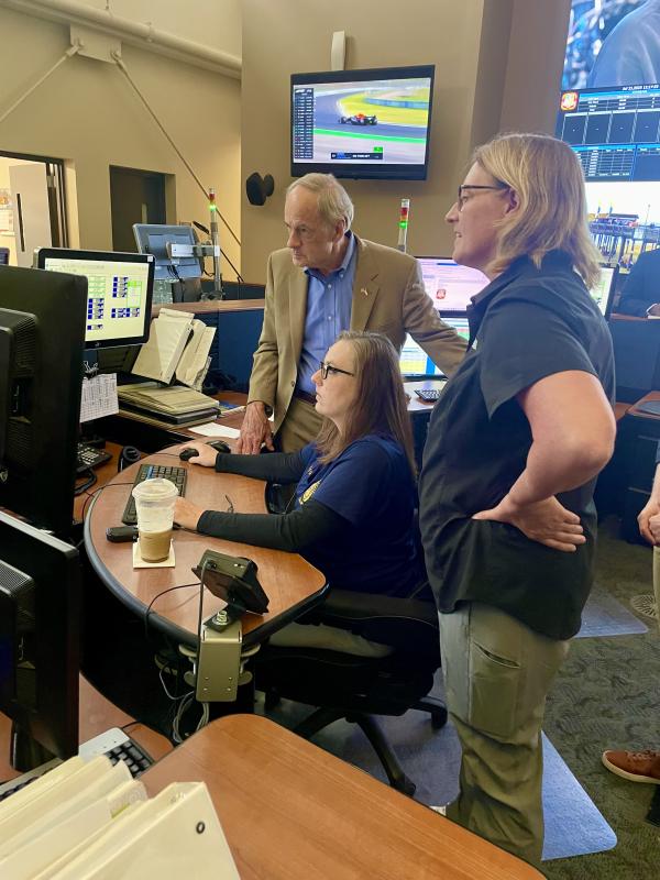 Sussex County dispatcher and trainer Tara Ritchie shows Sen. Tom Carper and FEMA Administrator Deanne Criswell how the 911 system operates.