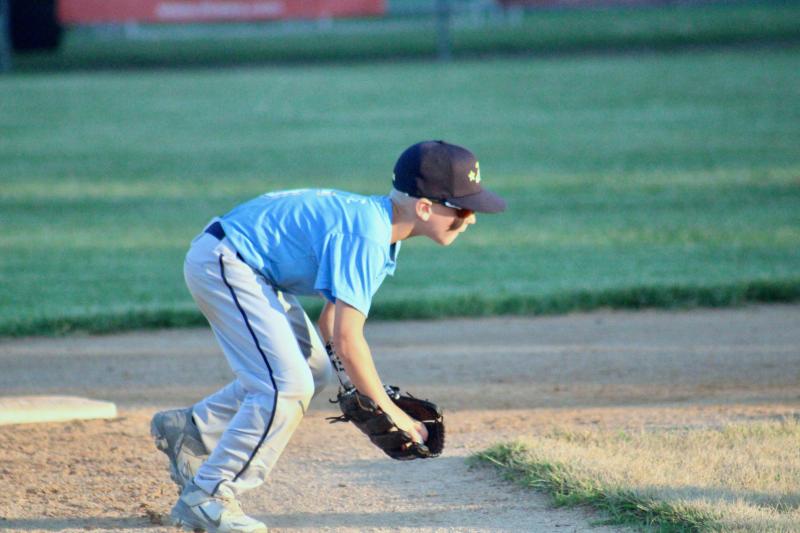 Lewes shortstop Ben Pease exhibits excellent fundamentals and sticks with a tough grounder to throw the runner out.