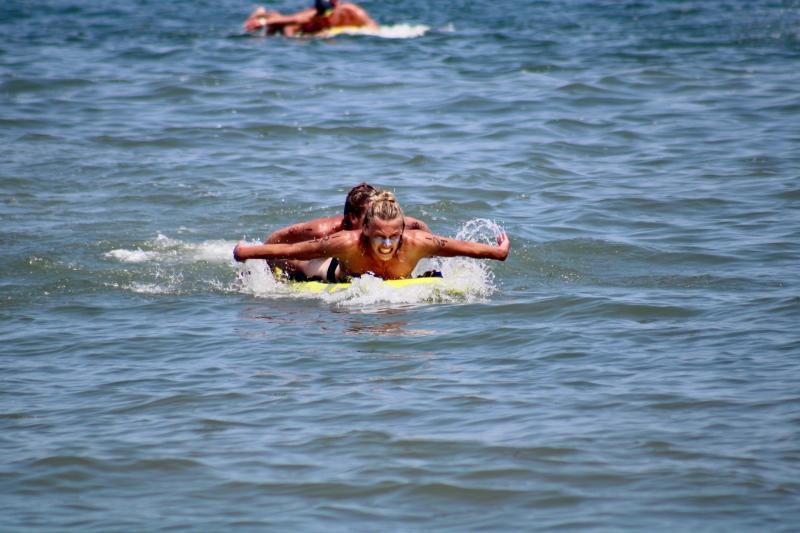 Half of the first-place Delaware Seashore State Park team paddles in during the board rescue event. Coleman Woodard and Josh Mcintire paddle up to the beach in unison to win first place.
