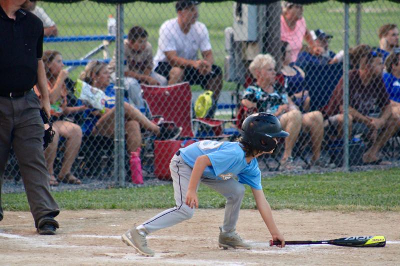 Safety first, then teamwork. Lewes outfielder Nolan Jones clears the bat off the baseline after first baseman Grant Hershelman drove him in during Game 2.