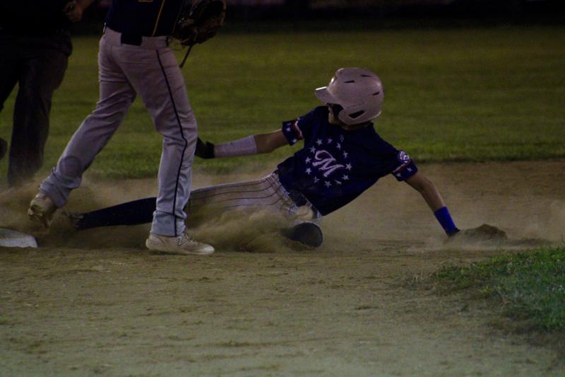 Milton Major All-Stars shortstop Trey Dickinson collects one of his two stolen bases in the third inning.