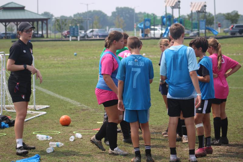 AFC Bournemouth trainer Stephanie Small delivers instructions to the oldest group of Delmarva Rush soccer players July 18.